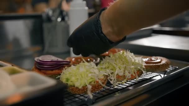 Процесс Приготовления Гамбургеров Повар Добавляет Ингредиенты Булочку Кухне Ресторана — стоковое видео
