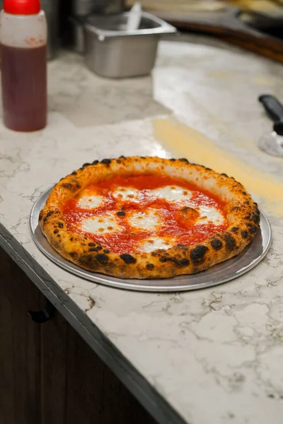 Delicious juicy Margherita pizza in restaurant kitchen. Traditional Italian cuisine