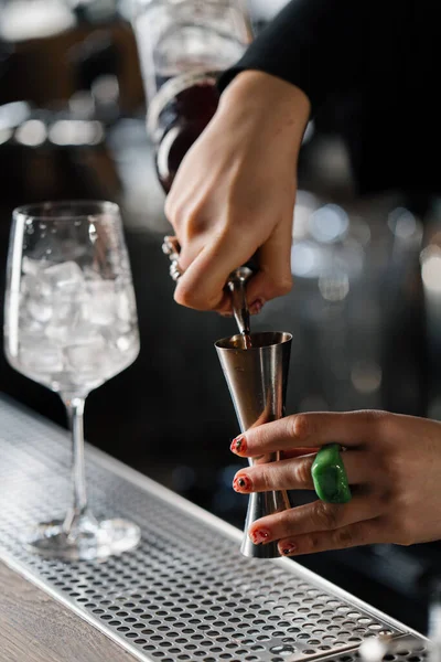 Close-up - the process of preparing a cocktail in a restaurant using shaker