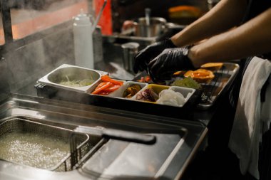 Profesyonel mutfak. Tezgahta malzeme depolamak için konteynırlar.