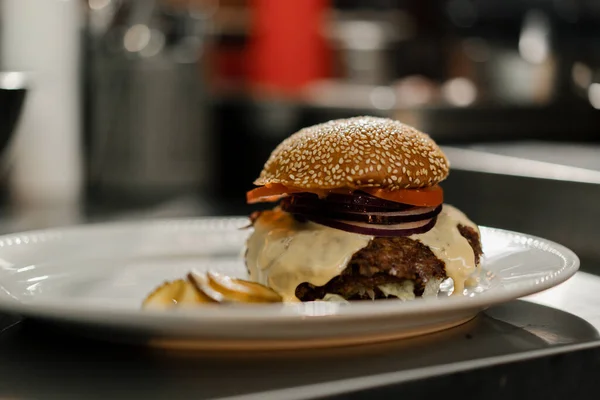 Close-up - burger on a table in a restaurant, working restaurant in blur against background