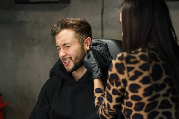 Tattoo Piercing Studio Woman Makes Ear Piercing Man Guy — Stock Photo, Image