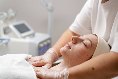 Bir kozmetik kliniğinde yüz hastasının cildini gençleştirmek için estetik ameliyat. Güzellik prosedürü uyguluyor.