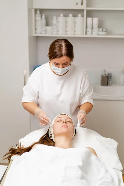cosmetic procedure to rejuvenate the skin of the face patient in a cosmetology clinic doctor does  beauty procedure