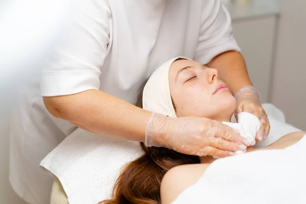 cosmetic procedure to rejuvenate the skin of the face patient in a cosmetology clinic doctor does  beauty procedure