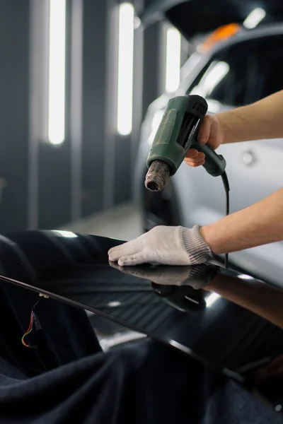 Worker Covers Car Spoiler Film Workshop Using Hair Dryer Spatula — Stock Photo, Image
