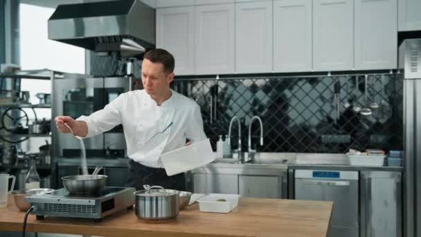 Professional Kitchen Chef Adding Sugar Hot Oatmeal Pot Preparing Breakfast — Stock Video