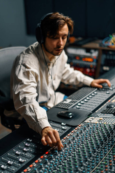 Sound engineer used digital audio mixer Sliders Engineer presses key Control panel Recording studio technician