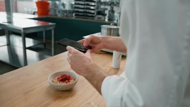 专业的厨房厨师在智能手机早餐上给新鲜准备的燕麦片和焦糖化水果拍照 — 图库视频影像