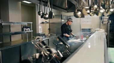 Otel restoranında profesyonel mutfak bıçaklı şef sebze burgeri keser.