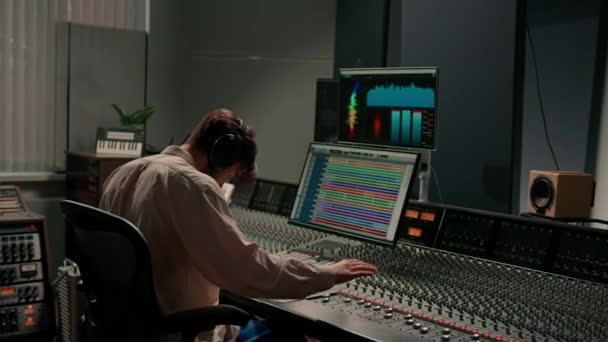 Energinen Audio Insinööri Tuottaja Työskentelee Tallennus Studio Sekoittamalla Kappaleen Konsolin — kuvapankkivideo