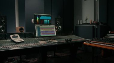 Ses dalgası ve ses ayarları olan bir ekran ile kayıt stüdyosu iki subwoofer ve karıştırma konsolu