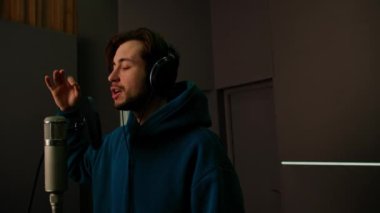 Kulaklıklı rap şarkıcısı. Profesyonel kayıt stüdyosunda duygusal olarak yeni şarkı kaydediyor.