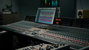 Ses dalgası ve ses ayarları olan bir ekran ile kayıt stüdyosu iki subwoofer ve karıştırma konsolu
