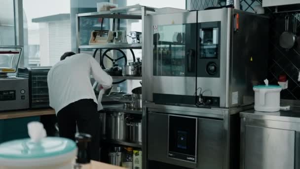 요리사는 기구를 요리하기 수건으로 프라이팬을 닦는다 — 비디오