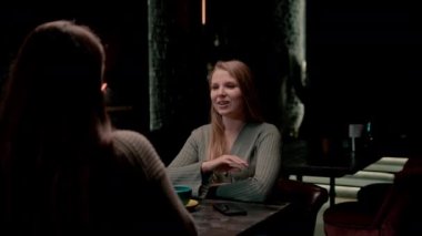 İki genç kız arkadaş bir nargile barında rahatça oturup eğlence kavramını tartışırlar.