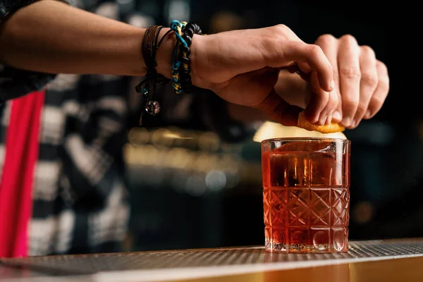 Barman Knijpen Een Stuk Sinaasappelschil Garnering Negroni Cocktail Aan Bar — Stockfoto