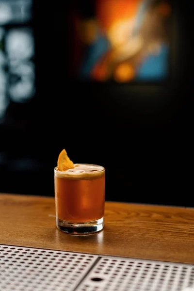 stock image Close-up of ready-made delicious alcoholic cocktail with Jager Sour with ice cube standing on bar and waiting guest