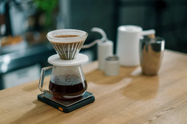 stock image The process of making filter coffee by pouring hot water over layer of ground coffee on the filter