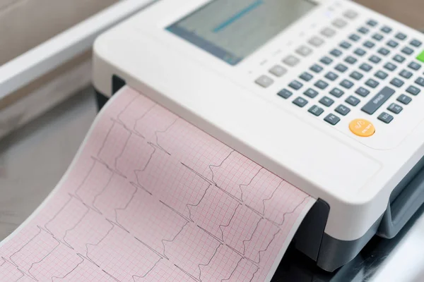 stock image a cardiologist makes an ECG cardiogram for a patient prints an analysis of patient's pulse rate and heartbeat in the clinic