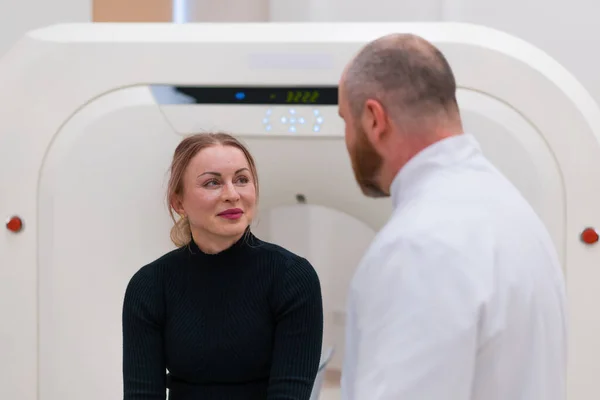 stock image A doctor consults a patient in a medical clinic before X-ray computed tomography procedure