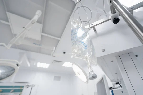 Intravenous saline bag in the operating room before the start of a surgical procedure in medical clinic