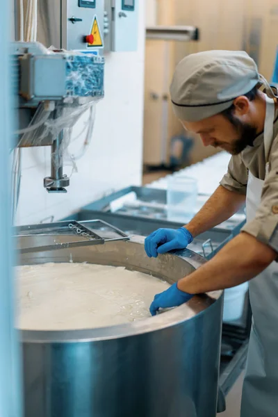 チーズ工場チーズメーカーでミルクミキシング 大型タンクで手作業でチーズをチェック 殺菌チーズ生産チーズ工場 — ストック写真