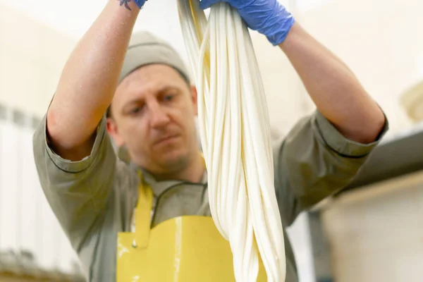 Production Dairy Cheeses Cheesemaker Sculpts Fresh Mozzarella His Hands Stretches — Stock Photo, Image