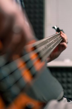 Kayıt stüdyosunda elektro gitarlı bir rock sanatçısı kendi şarkısını çalıyor şarkı enstrümanlarını yaratıyor.