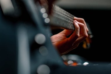 Kayıt stüdyosunda elektro gitarlı bir rock sanatçısı kendi şarkısını çalıyor şarkı enstrümanlarını yaratıyor.
