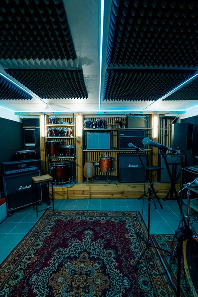 empty professional recording studio with musical instruments drums speaker rack with microphone neon light