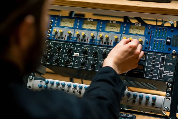 Sound engineer used digital audio mixer Sliders Engineer presses key Control panel Recording studio technician closeup
