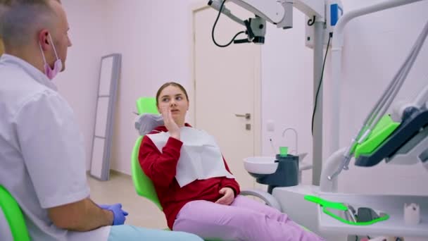 Upset Female Patient Dentist Appointment Complains Toothache Caries Holding Her — Stock Video