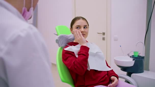 Upset Female Patient Dentist Appointment Complains Toothache Caries Holding Her — Stock Video