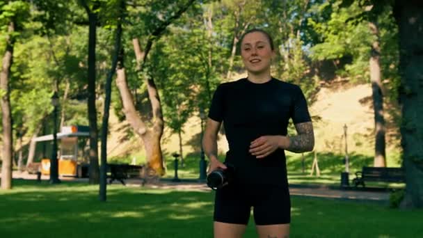 Portrait Young Satisfied Sports Girl Throwing Water Bottle Sky Outdoors — Stock Video