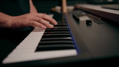 profesyonel kayıt stüdyosu ses mühendisi müzik yapımcısı sentezleyici tuşlarına basan müzisyen