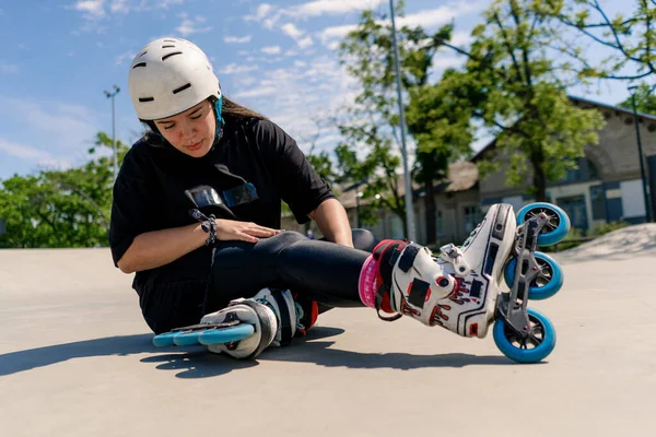 upset annoyed girl rollerblading on roller drome throws protective helmet asphalt active recreation skating sport hobby