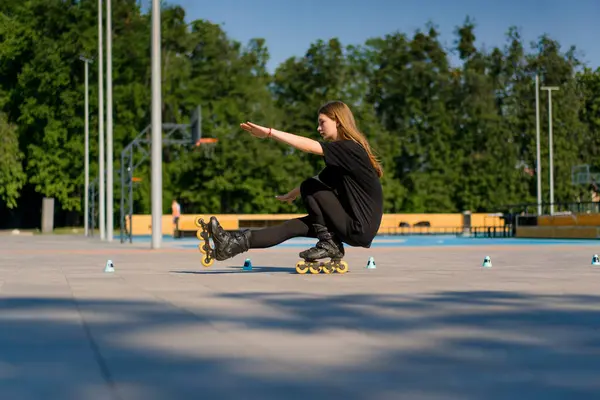 Спортивна Дівчина Практикує Трюки Роликових Ковзанах Парку Міському Фоні Насолоджуючись — стокове фото