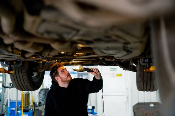 Male Auto Mechanic Flashlight His Hands Inspects Bottom Car Looks — Stock Photo, Image