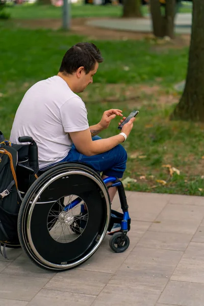Inclusiveness Focused Man Disabilities Wheelchair Stares Smartphone Holding City Park — Stock Photo, Image