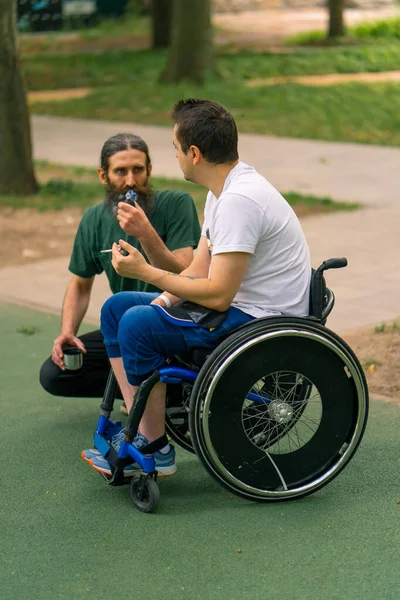Inclusiveness Man Disability Interacts Elderly Man Smoking Pipe City Park — Stock Photo, Image