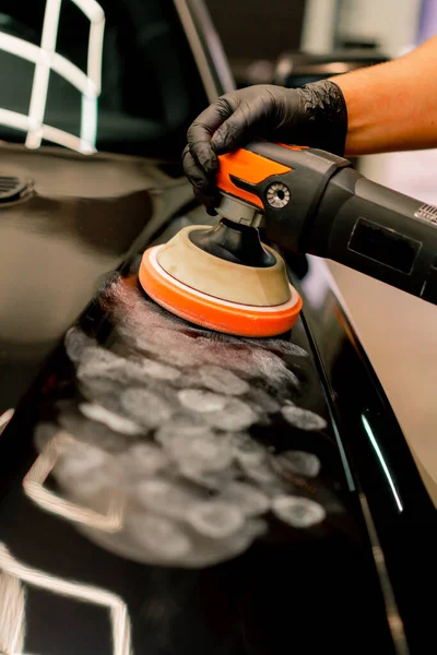 黒い高級車のフードを磨く磨く機械を使用して洗車労働者の閉鎖 — ストック写真