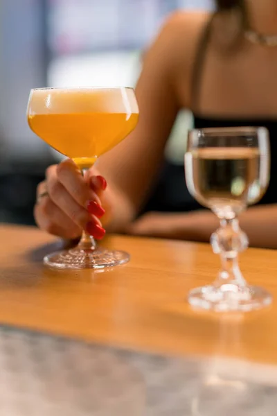 バーやクラブのバーの飲み物のコンセプトからアルコールカクテルを取るバーのお客様の手のクローズアップ — ストック写真