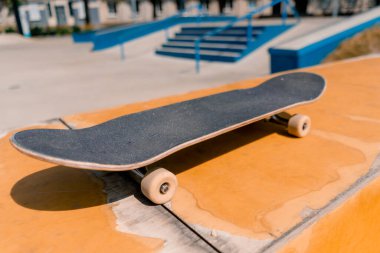 Kaykay pistinde bir bankta duran kaykayın yakın çekimi adrenalin tutkusu ve kaykay sevgisi kavramı.