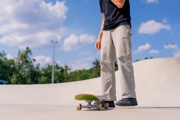 クローズアップ若いスケートボーダーの男は彼の手でスケートボードを投げ 都市のスケートパークでスタントを行うしようとします — ストック写真