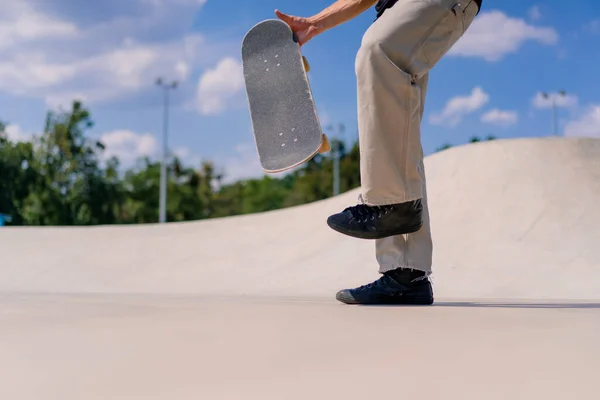 클로즈업 스케이트 남자는 손으로 스케이트 보드를 던지고 스케이트 공원에서 스턴트를 — 스톡 사진