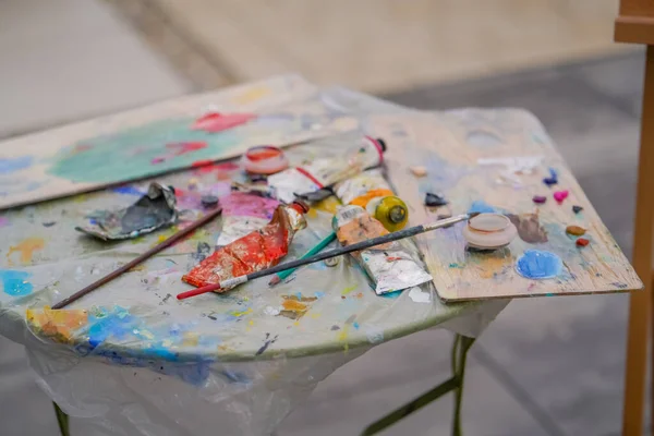 Close-up of paint palettes that have traces of oil paint in the studio for painting concept of love of fine art