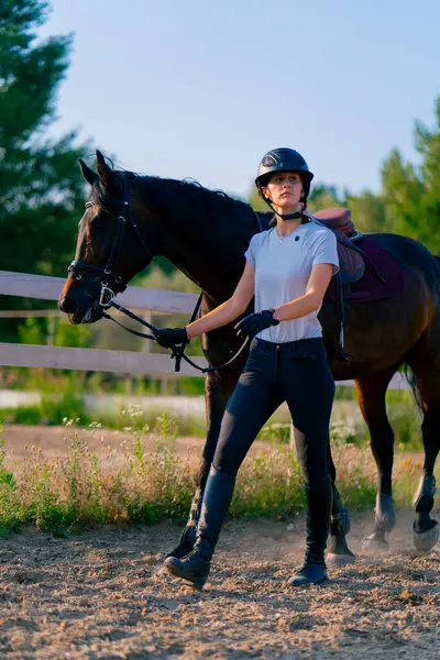 Helmeted Rider Leads Her Beautiful Black Horse Harness Riding Arena — Stock Photo, Image