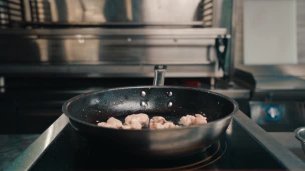 餐馆里的一个专业厨房里的厨师在平底锅里煎多汁的鸡排 — 图库视频影像