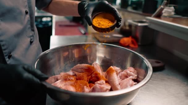食肆专业厨房内穿着黑色手套调料生鸡翅的特写生厨师 — 图库视频影像